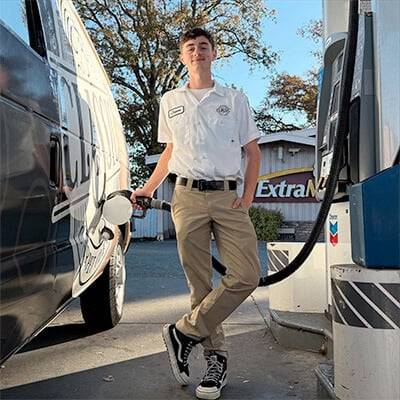 Technician fueling the service van before a job