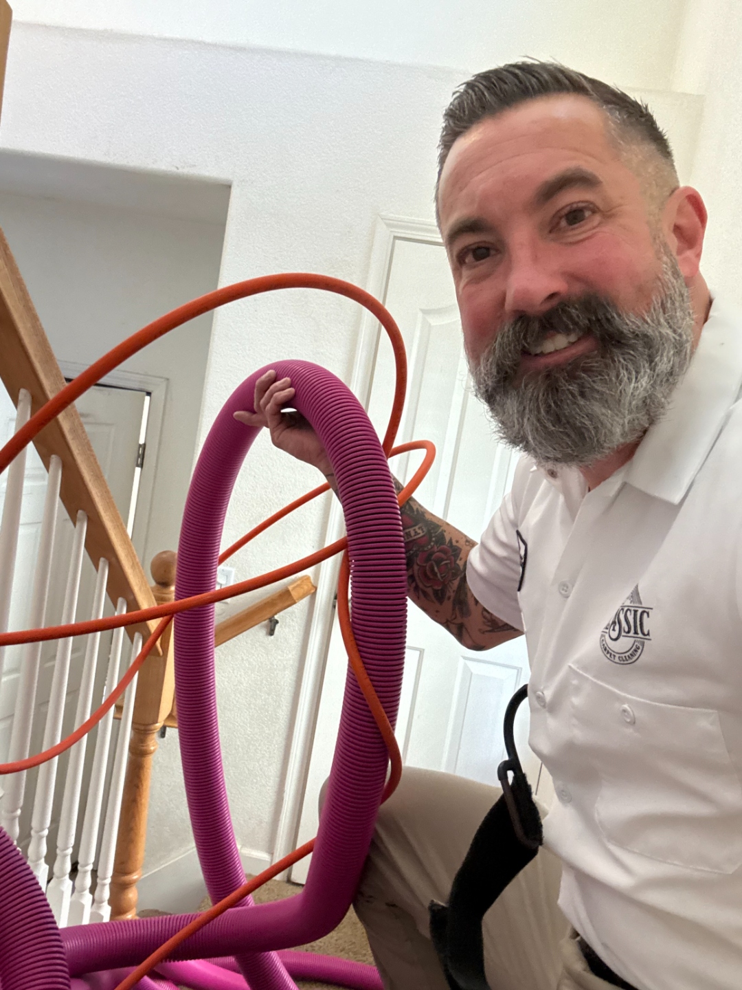 Matthew LaMont, Owner, holding extraction hoses on a job